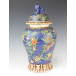 An 18th Century style Chinese baluster vase and cover, the blue ground decorated with flowers,