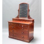 A Victorian mahogany dressing chest with arched plate mirror fitted 4 glove drawers above 2 short