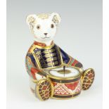 A Royal Crown Derby paperweight in the form of a teddy bear drummer with interlaced double M