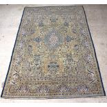 A yellow and green ground Qum carpet with central medallion 321cm x 208cm The fringe has been