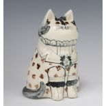 A Rye Pottery David De Bethel cat with glass eyes, dated 1986, decorated a floral frock coat 17cm