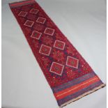 A blue and red ground Mashwani runner with 15 diamonds to the centre 255cm x 63cm