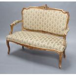 A French carved gilt hardwood 2 seat salon sofa upholstered in green and gold sculptured material,