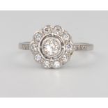 A platinum diamond cluster ring 0.7ct, size M 1/2