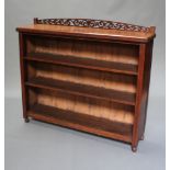 A Victorian mahogany bookcase with pierced arched back fitted 3 shelves raised on bun supports 105cm