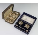 Six cased Sterling silver table salts, a teak cased silver salts and 1 spoon, 132 grams