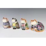 Three Rye Cinque Port pottery figures of seated cats, dressed, together with a reclining cat