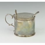 A circular silver mustard pot with S scroll handle, Birmingham 1917, 136 grams