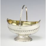 A Victorian demi-fluted silver boat shaped sugar bowl with swing handle, Sheffield 1893, 13cm, 146