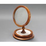 A Victorian circular plate shaving mirror raised on a turned column and circular white marble base