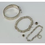 A silver bangle and minor silver jewellery, 100 grams