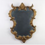 An Italian style shaped plate wall mirror contained in a painted gilt frame 57cm x 41cm