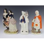 A Victorian Staffordshire group of a lady and gentleman holding a dog 33cm, a ditto of a lady 28cm