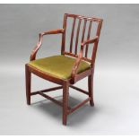 A 19th Century mahogany stick and rail back carver chair with upholstered drop in seat There is a