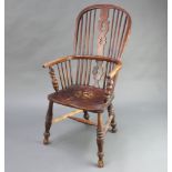 An 18th/19th Century elm Windsor stick and rail back kitchen carver chair with solid seat and H