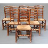 A set of 6 19th Century elm ladderback dining chairs with woven rush seats raised on turned
