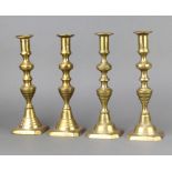 A set of 4 19th Century brass candlesticks with knopped stems and ejectors 25cm 1 has a loose stem