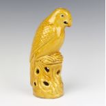 A Chinese yellow glazed figure of a cockatoo 21cm, Chinese painted glass snuff bottle with floral