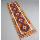 A red, blue and brown ground Mashwani Kilim runner with all over geometric design 203cm x 60cm