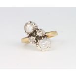 An 18ct yellow gold crossover mine cut diamond ring with 2 larger stones enclosing 2 small stones