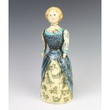 A Rye Pottery figure by Joan De Bethel of a standing lady with swing arms, painted with flowers