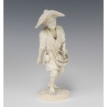 A good Japanese Meiji period carved ivory figure of a standing farmer wearing a broad brimmed hat