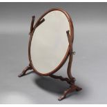 A Sheraton style oval plate dressing table mirror contained in a mahogany swing frame 56cm h x