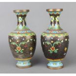 A pair of cloisonne black ground and floral patterned club shaped vases 23cm x 7cm Both vases have
