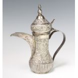 A Persian repousse silver baluster coffee pot decorated with formal scrolling flowers, 486 grams,