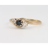 An 18ct yellow gold 3 stone diamond and sapphire ring, 1.6 grams, size R