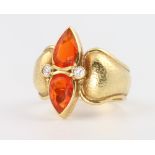 An 18ct yellow gold fire opal and diamond ring 10.7 grams, size P