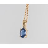 A 9ct yellow gold sapphire pendant and chain