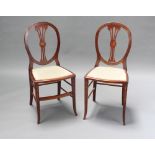 A pair of Edwardian Sheraton Revival painted mahogany bedroom chairs with vase shaped splat backs