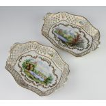 A pair of rounded rectangular Dresden baskets with pierced borders and riverscape panels 26cm