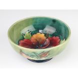 A Walter Moorcroft deep bowl, the green ground decorated the Hibiscus design, the base with