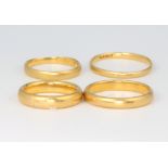 Four 22ct yellow gold wedding bands size G, H, N and O 1/2, 14 grams