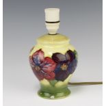 A Moorcroft baluster table lamp, the green yellow ground decorated the anemone design, 14cm