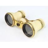 V Curvilinear, a pair of opera glasses in gilt metal and ivory case (some damage to the ivory and