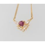 An 18ct yellow gold diamond and ruby pendant and chain, the diamond approx. 0.44ct