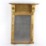 A Regency rectangular plate pier mirror contained in a decorative gilt frame supported by pillars