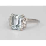 A platinum aquamarine and diamond ring, the centre stone approx. 2.15ct flanked by 3 brilliant