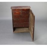 An 18th Century elm hanging cabinet, the interior fitted 6 short drawers above 1 long drawer with