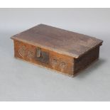 A 17th/18th Century carved oak bible box with chip carving to the edge, the apron carved roundels