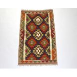 A black, brown and white ground Maimana Kilim rug with all over geometric design 134cm x 81cm