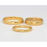 Three, 22ct yellow gold wedding bands, 13.6 grams, sizes N, N 1/2 and S