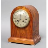 An Edwardian striking mantel clock with silvered dial and Roman numerals contained in arch shaped