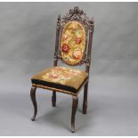 A Victorian Continental carved oak hall chair, the seat and back upholstered in tapestry material,