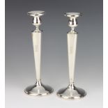 A pair of Sterling silver tapered candlesticks with engraved monogram 25cm