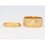 An 18ct yellow gold wedding band size O, 10 grams and a 22ct gold ditto size K, 2 grams