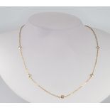 A 14ct yellow gold diamond set necklace, the diamonds approx. 0.25ct